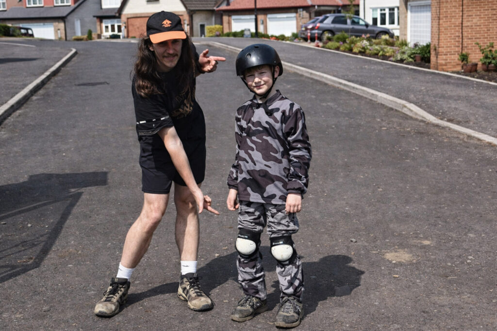 Kid with helmets and pads.